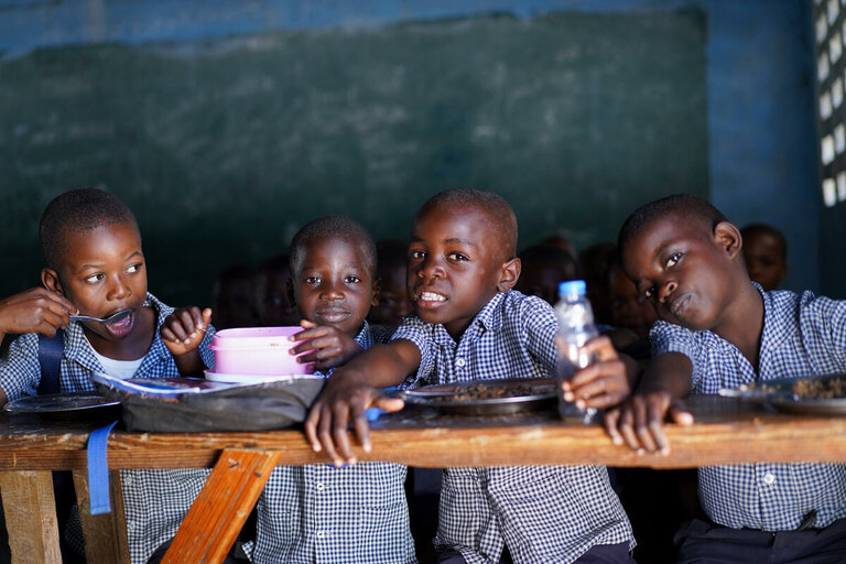 neljä lasta istuu luokkahuoneessa