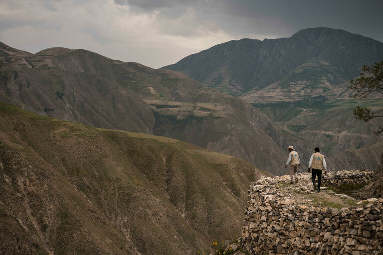 Kaksi WFP:n työntekijää kävelee vuorella