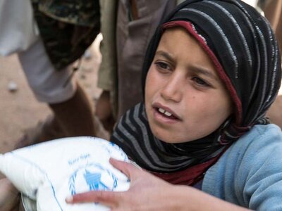 child clutching food bag