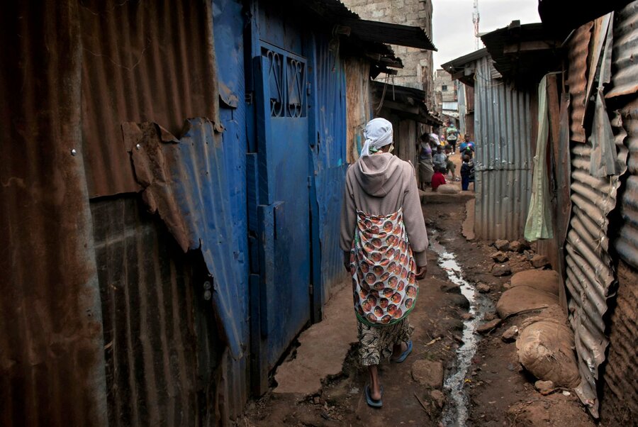 A woman walks through the narrow alleyways of the Huruma informal urban settlement in Nairobi. Photo: WFP/Alessandro Abbonizio