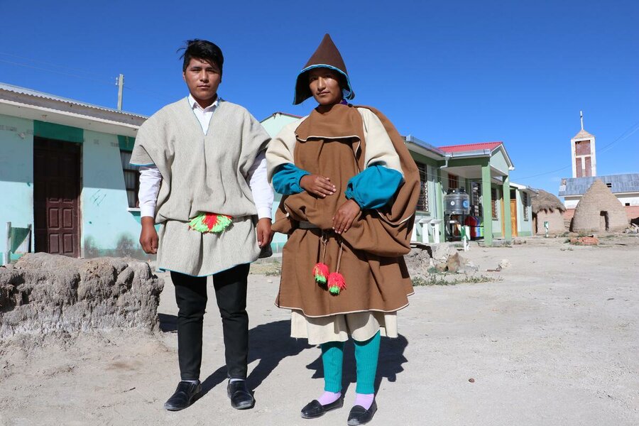 Young man and women in traditional Indigenous clothing in Bolivia